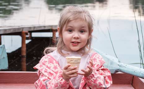 girl on paddleboat with ice cream